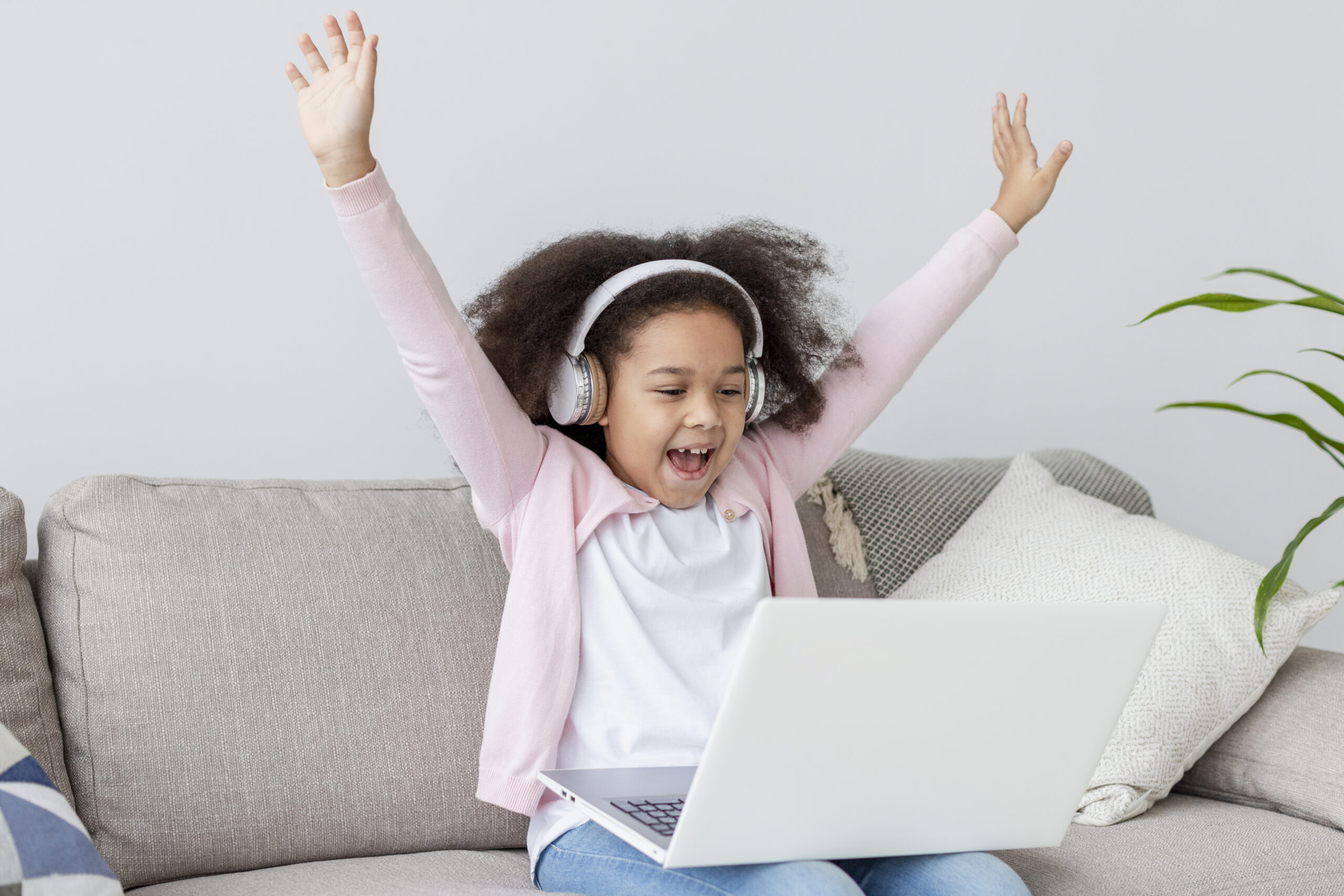 happy young girl watching cartoons laptop scaled